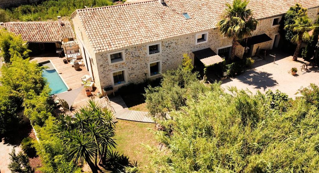 an aerial view of a house with a swimming pool at Le Mas Des Brune in Saint-Laurent-dʼAigouze