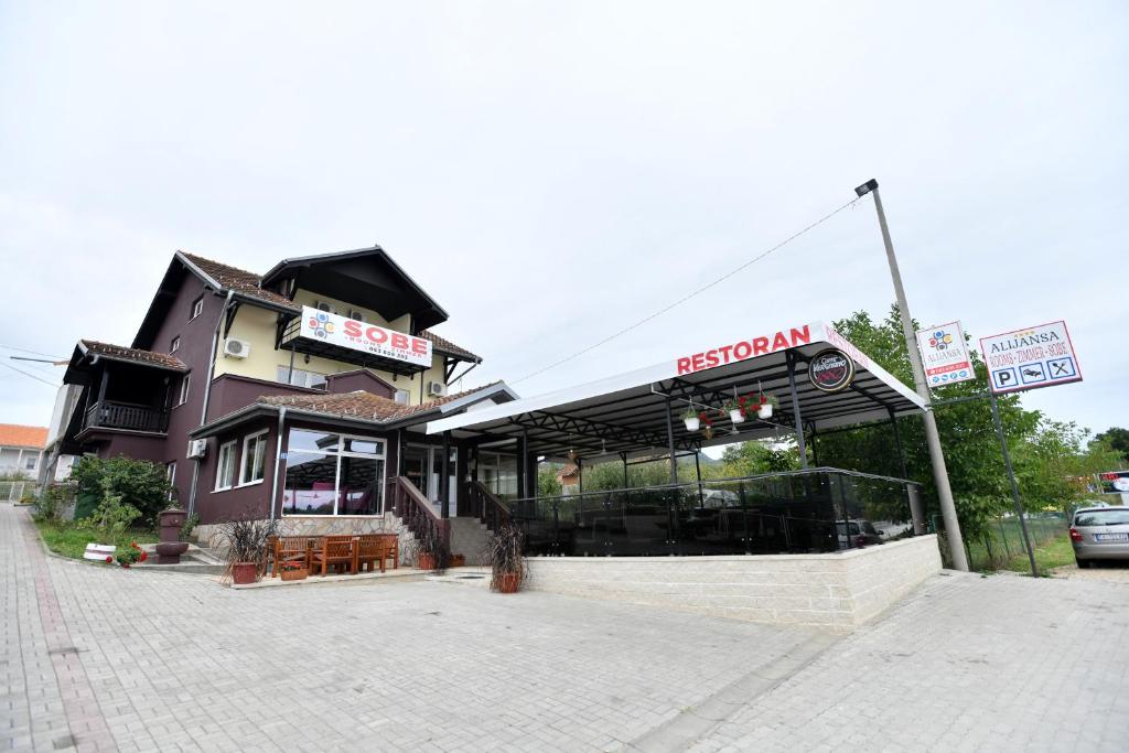 a restaurant sitting on the side of a street at Alijansa in Čačak
