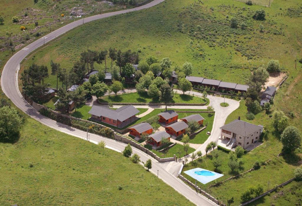 an aerial view of a house with a pool at Cabañas Maleixas in El Puente