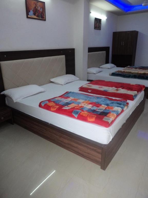 a large bed in a room with two beds at Hotel Dimple in Mount Ābu