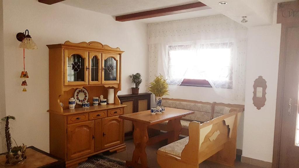 a living room with a wooden cabinet and a table at Willa na Skarpie in Oświęcim