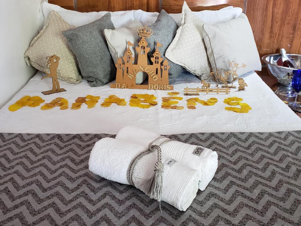 a bed with a castle and towels on it at Rancho da Doris in Barra de São Miguel