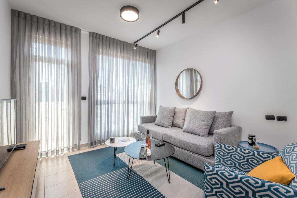 a living room with a couch and a table at Charming 1 BDR with balcon close to Hilton beach in Tel Aviv