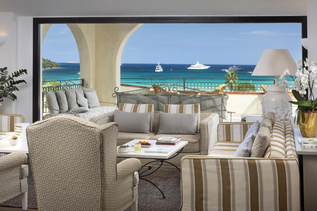 a living room with couches and a view of the ocean at Hotel Abi d'Oru in Porto Rotondo