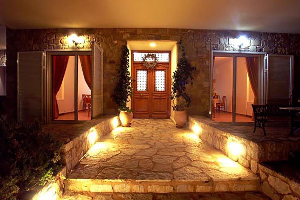 a house with aoyer with a door and lights at Bisti Guesthouse in Ermioni