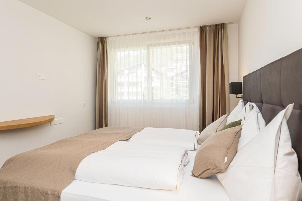Postel nebo postele na pokoji v ubytování Matthiol Appartements