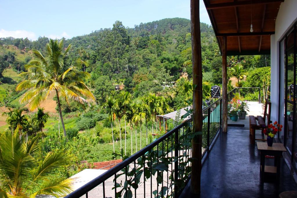 a balcony of a house with a view of a forest at Cascade Vally in Ella