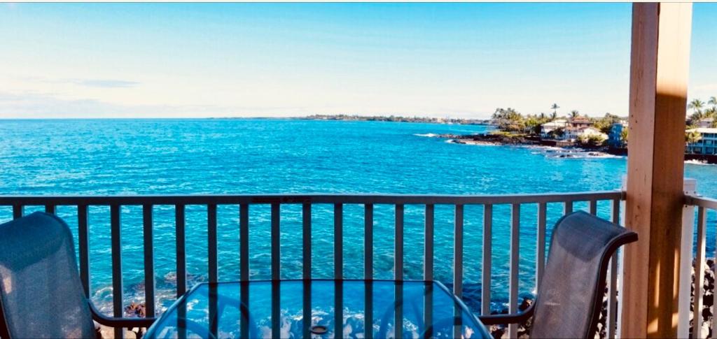 a view of the ocean from a balcony at Sea Village 2nd floor Direct Oceanfront unit with extensive upgrades in Kailua-Kona