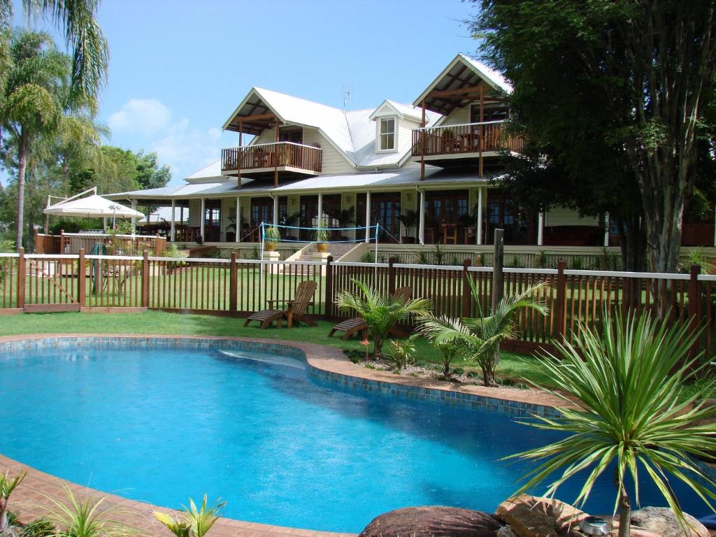 a house with a swimming pool in front of a house at Clarence River Bed & Breakfast in Grafton