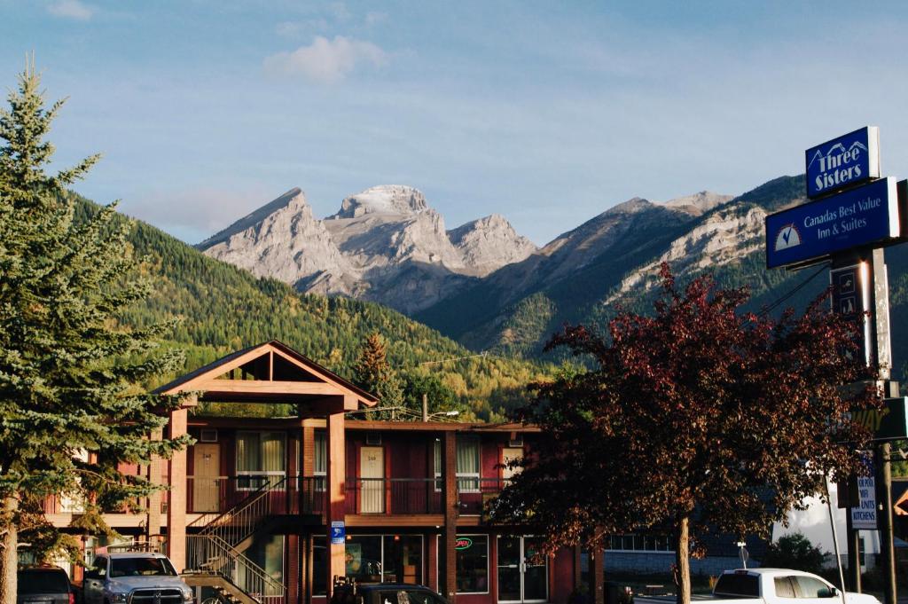 a building with a mountain range in the background at Canadas Best Value Inn and Suites Fernie in Fernie