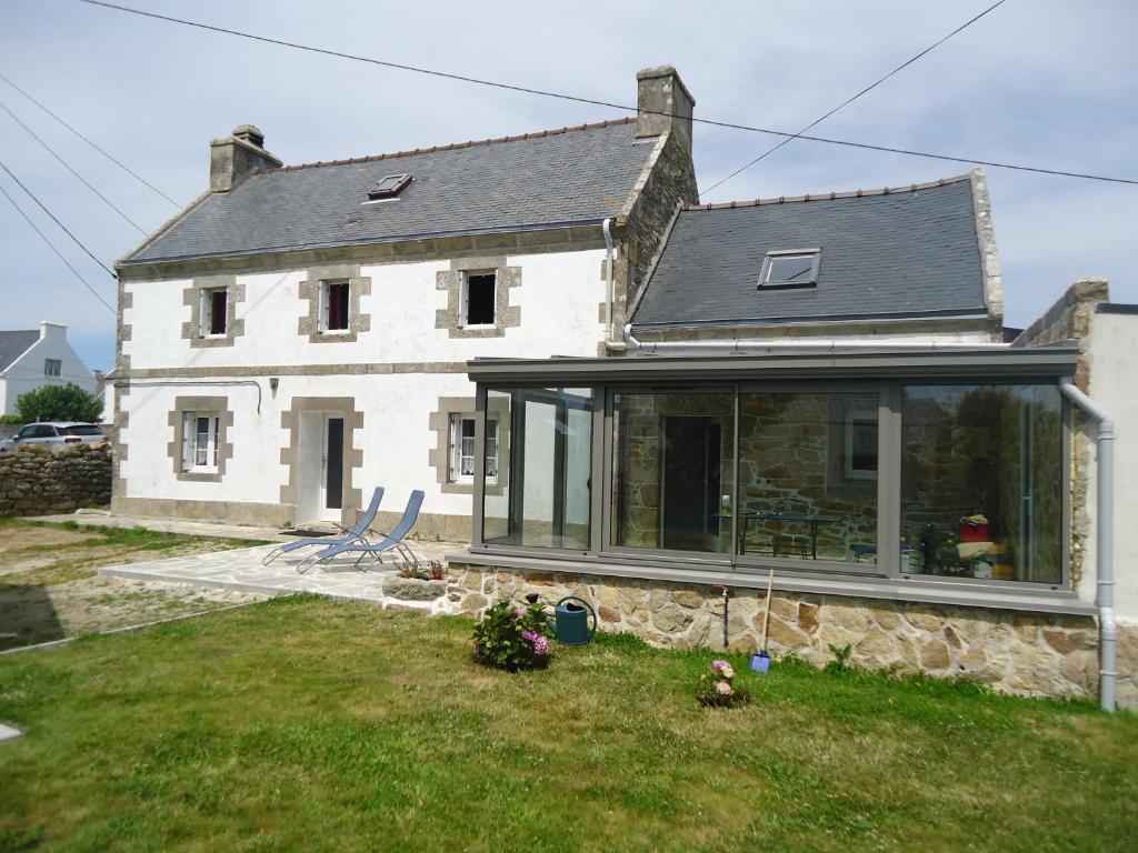 a house with large glass doors on the front of it at L' Iroise in Plogoff