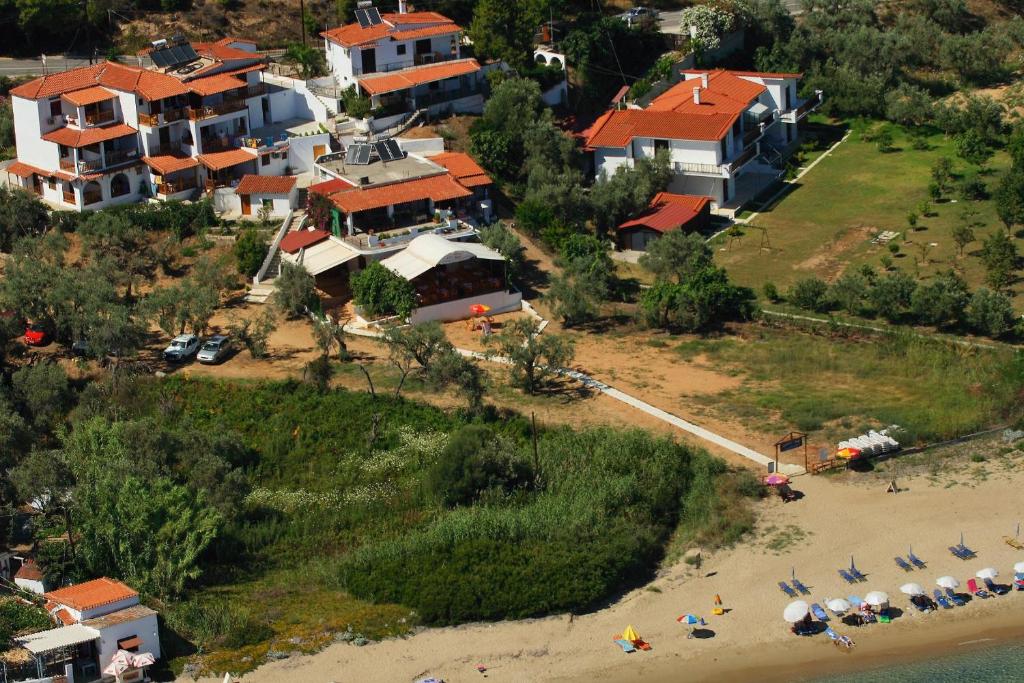 an aerial view of a house and a beach at Villa Zaharo and Lilian Apartments in Troulos