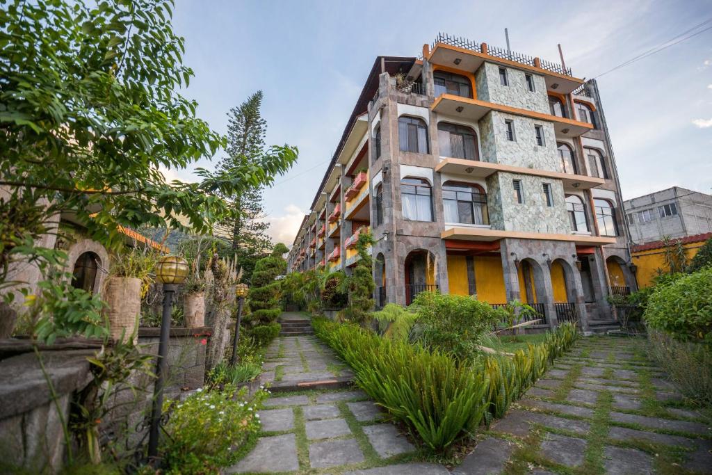 an old building with a walkway in front of it at Hotel Tiosh Abaj in Santiago Atitlán
