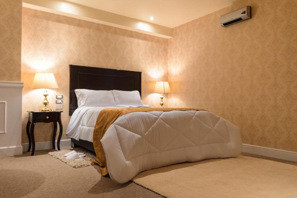 Postel nebo postele na pokoji v ubytování Hotel Paradis Suite Cusco