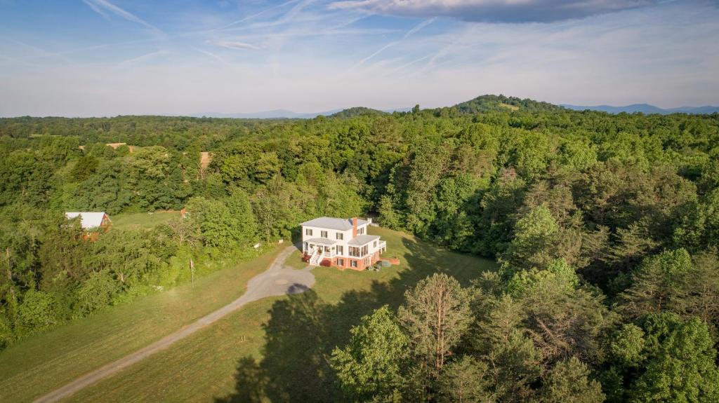 an aerial view of a house in the middle of a forest at Hill of Content B&B in Radiant
