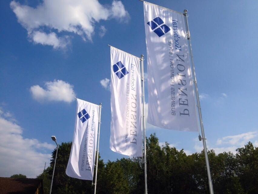 a group of white flags flying in the sky at Pension Kochertal in Aalen