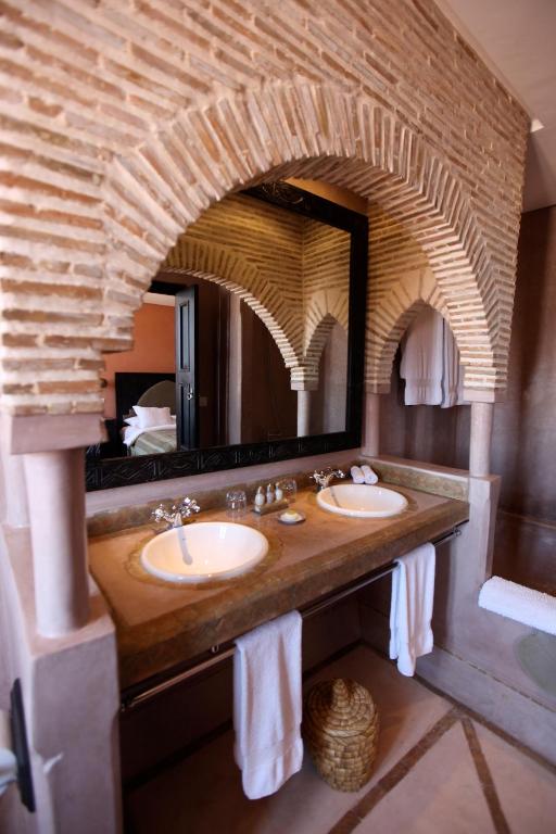 a bathroom with two sinks and a large mirror at Riad Dar Haven in Tamraght Ou Fella