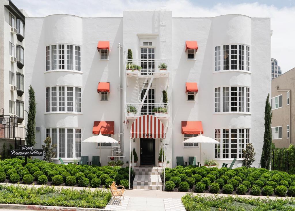 a white building with a dog in front of it at Palihotel Westwood Village in Los Angeles