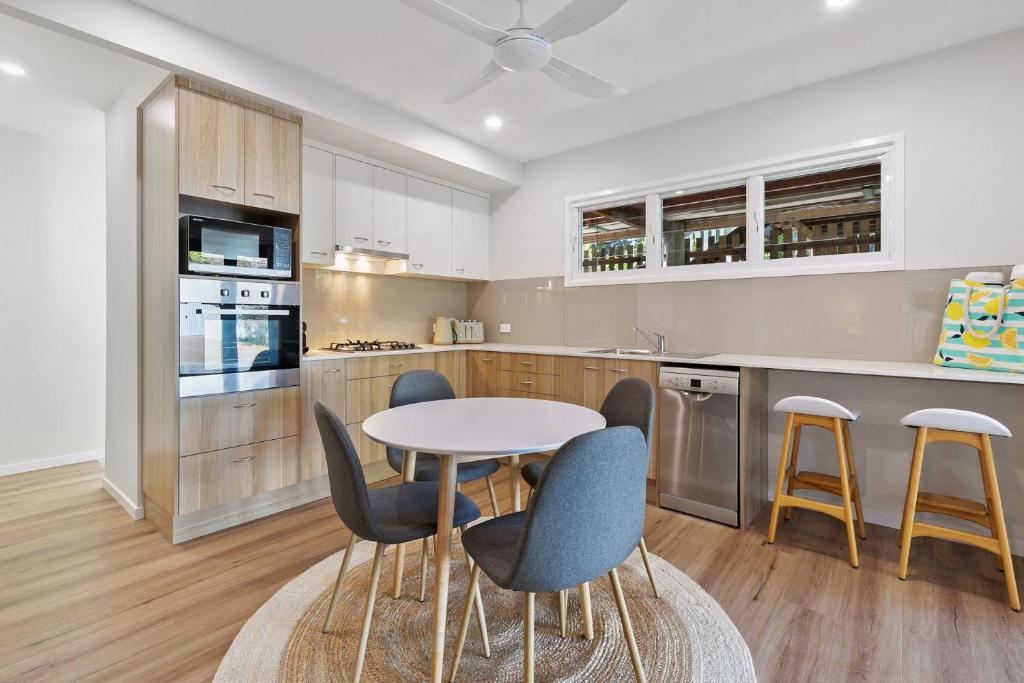 a kitchen with a table and chairs in it at Day Dreaming in Point Lookout