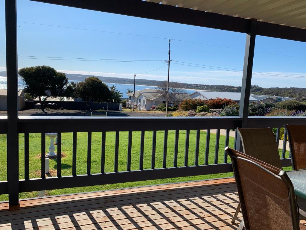 a balcony with two chairs and a view of the ocean at Sunny Brae in Emu Bay