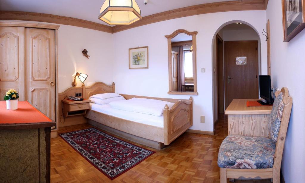 Łóżko lub łóżka w pokoju w obiekcie Hotel Dolomiti Madonna