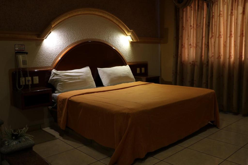 Postel nebo postele na pokoji v ubytování Motel Caribe
