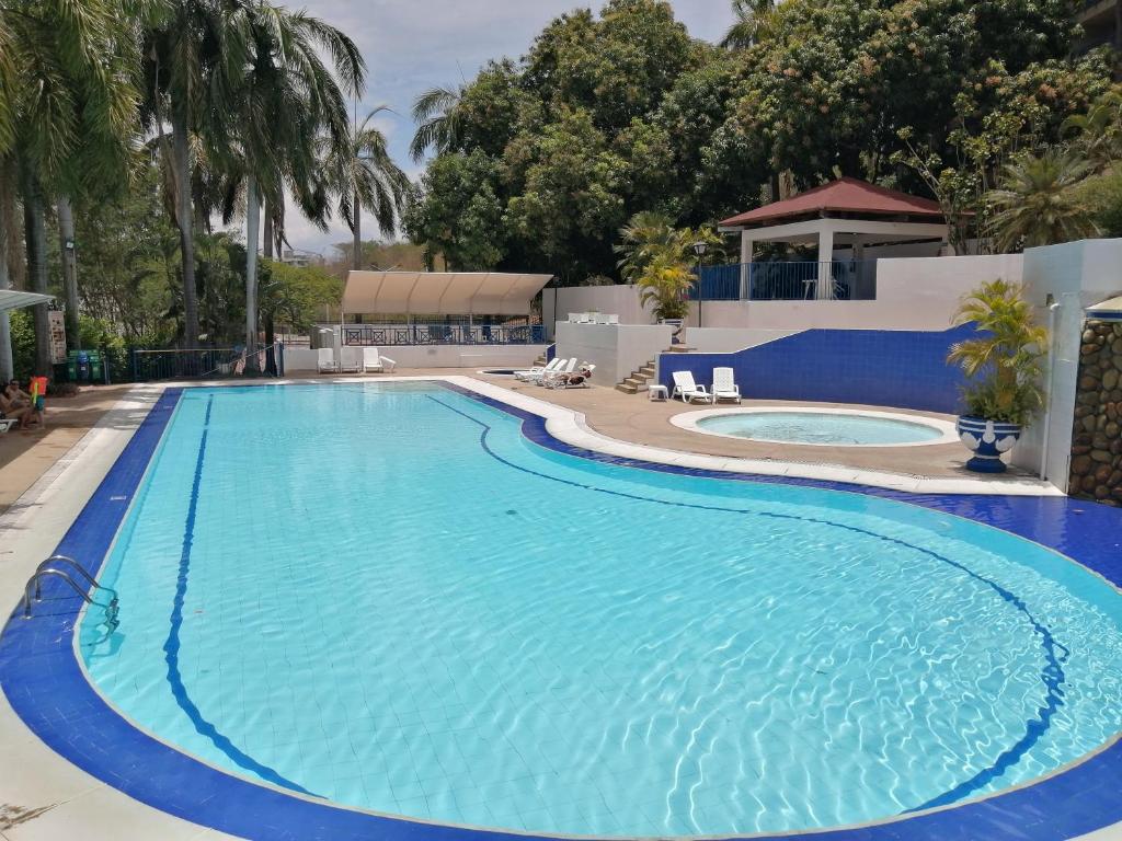 a large swimming pool with blue water at Girardot Resort in Girardot