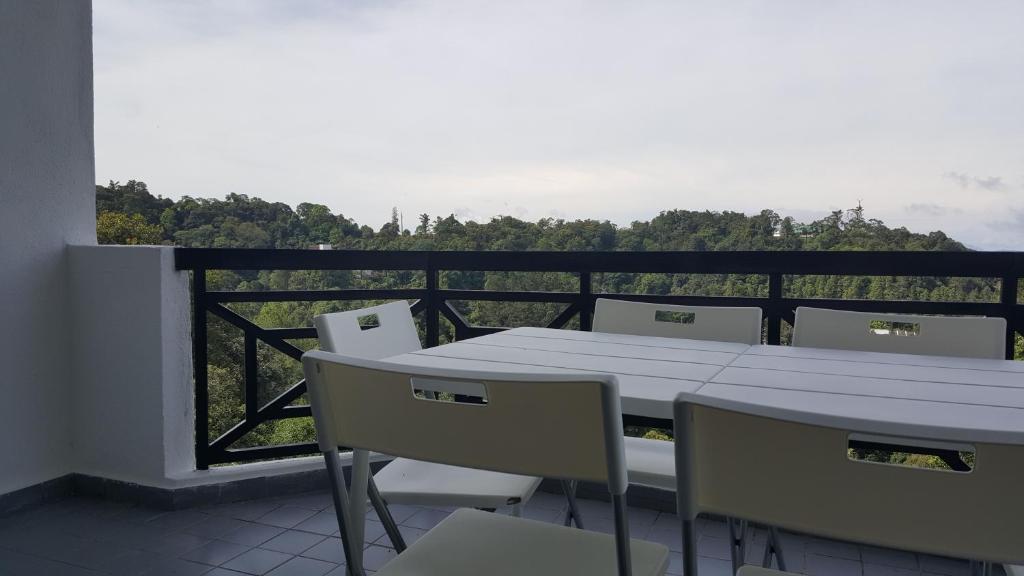 a table and chairs on a balcony with a view at Silverpark Resort C2-5-1 or C3-3A-2 walk up in Bukit Fraser