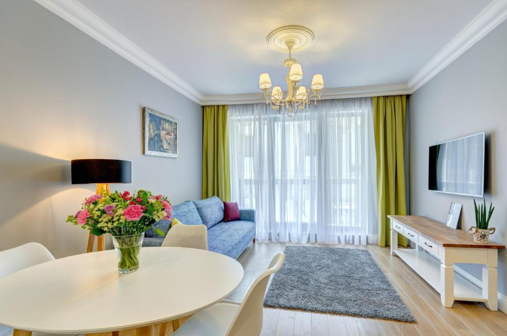 Televízia a/alebo spoločenská miestnosť v ubytovaní Unique Apartments - Browar Gdański