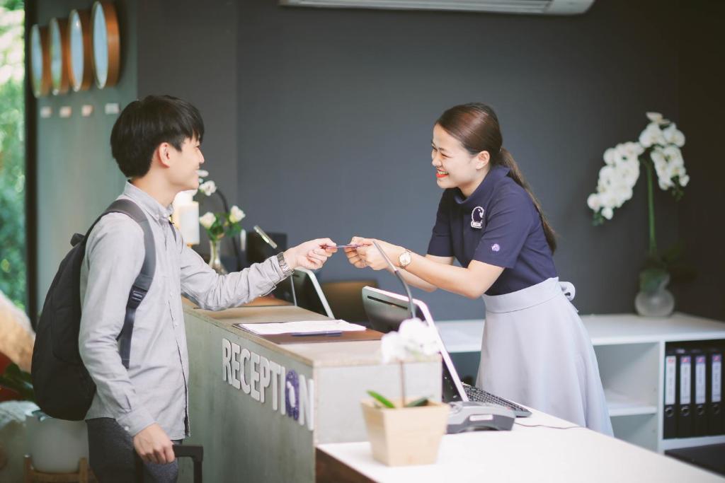 A close view of a guest checking in at the reception counter.