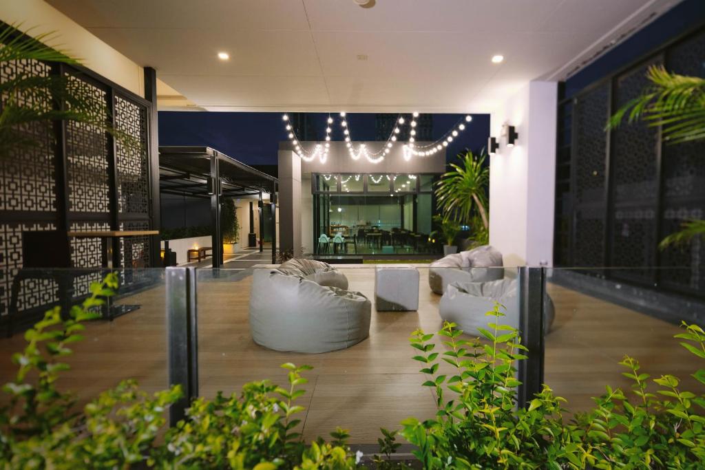 A landscaped lobby lounge offers beanbag seating beneath decorative string lights.