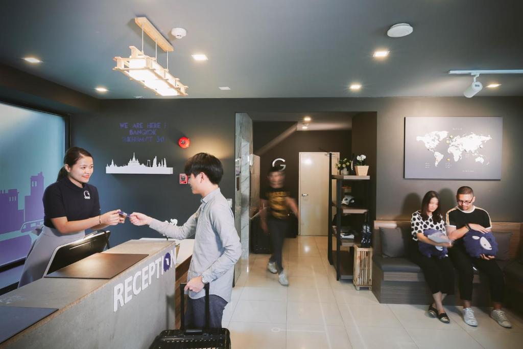 A compact, warmly lit lobby with a reception desk and a small waiting area.