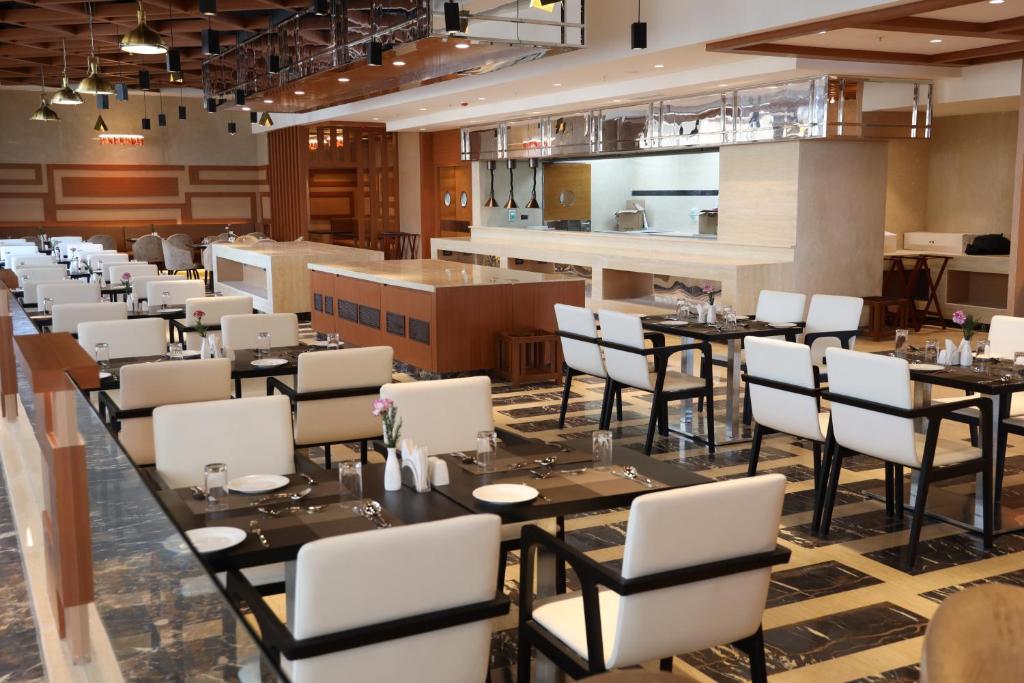 a dining room filled with tables and chairs at Regenta Central RS Chennai OMR SIPCOT in Chennai