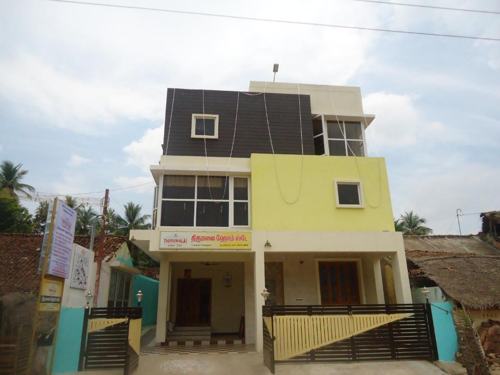 a house with a solar roof on top of it at Thirumalai Home Stay - Group & Family Stay Room VL Swami Malai Temple in Kumbakonam