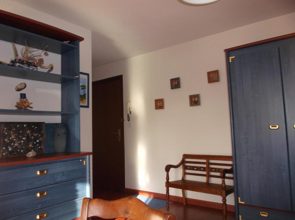 a bedroom with a blue dresser and a blue cabinet at résidence de la plage in Jullouville-les-Pins