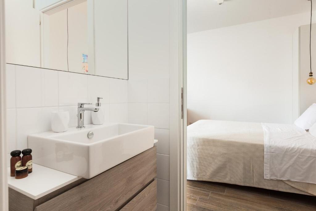 Posteľ alebo postele v izbe v ubytovaní MI HOME NAVIGLI