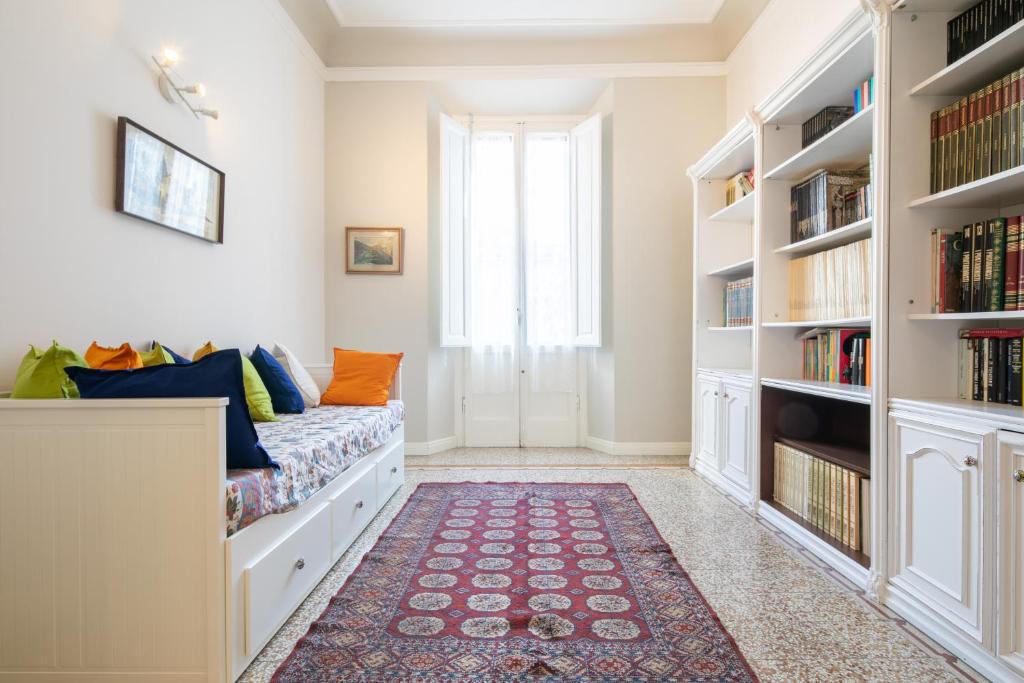 a room with a bed and bookshelves at Santa Maria Novella 4 bedrooms in Florence