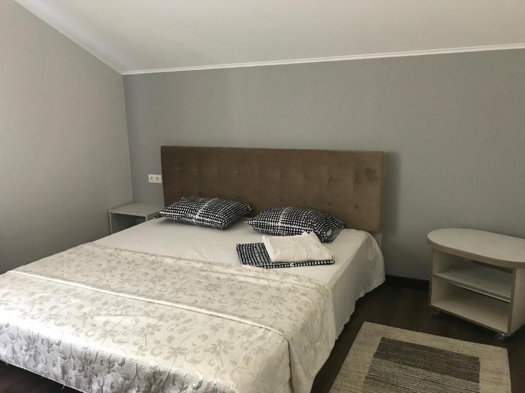 a bedroom with a bed with two pillows on it at Guest House Olzhycha 45 Б in Kyiv