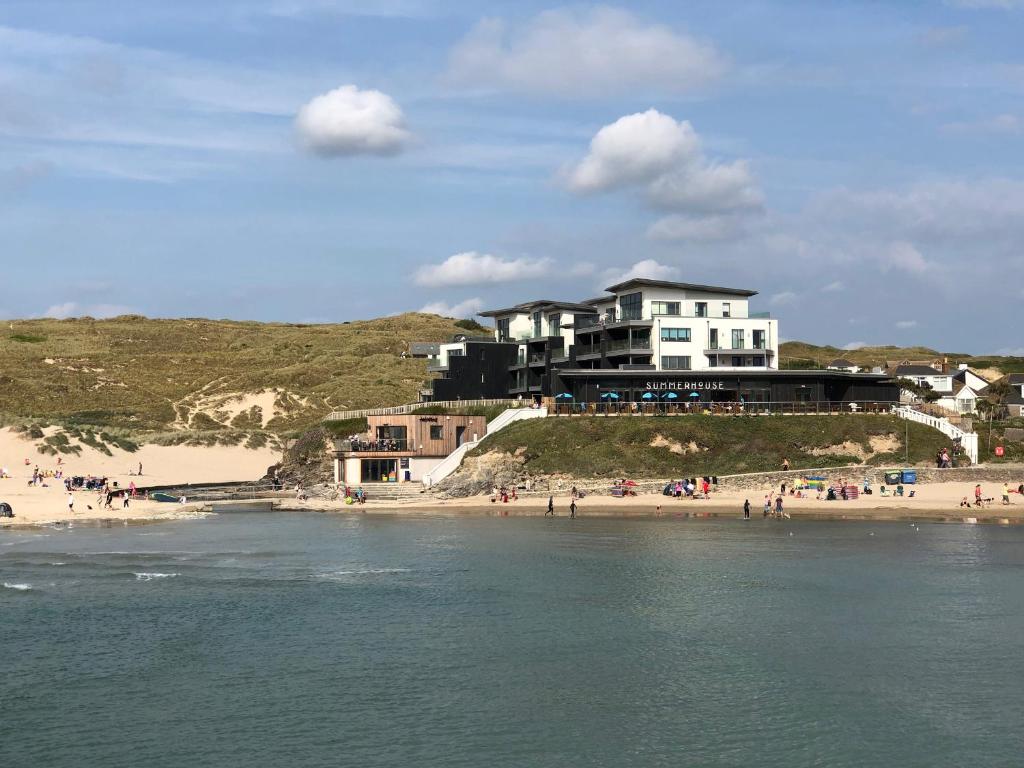 a building on a hill next to a beach at Chapel Rock View, The Dunes in Perranporth