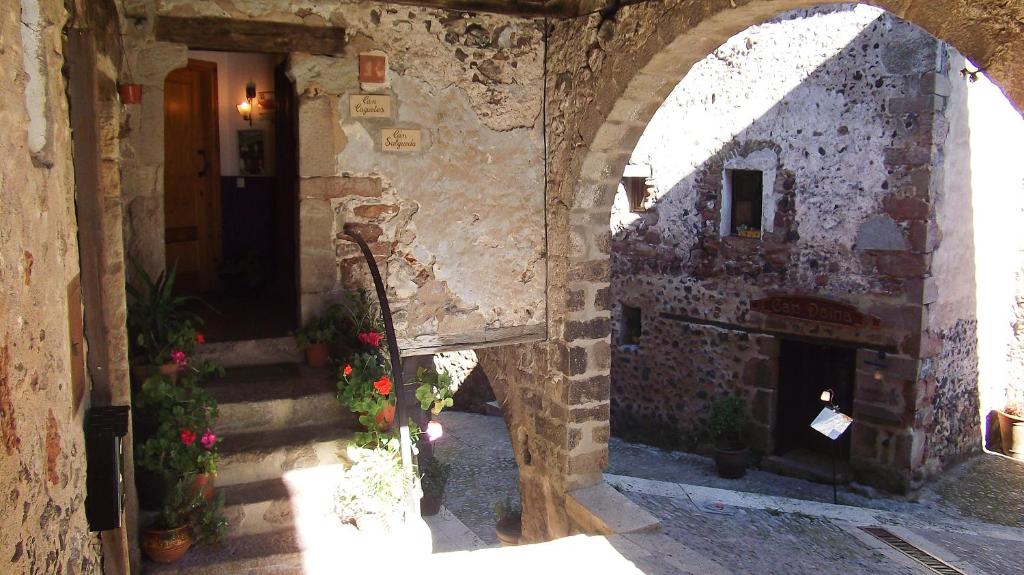 une arche dans un bâtiment avec une cheminée dans l'établissement Can Salgueda, à Santa Pau