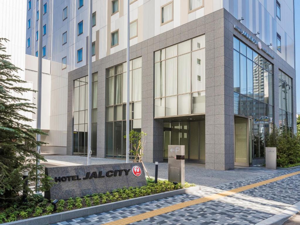 a building with a sign in front of it at Hotel JAL City Sapporo Nakajima Park in Sapporo