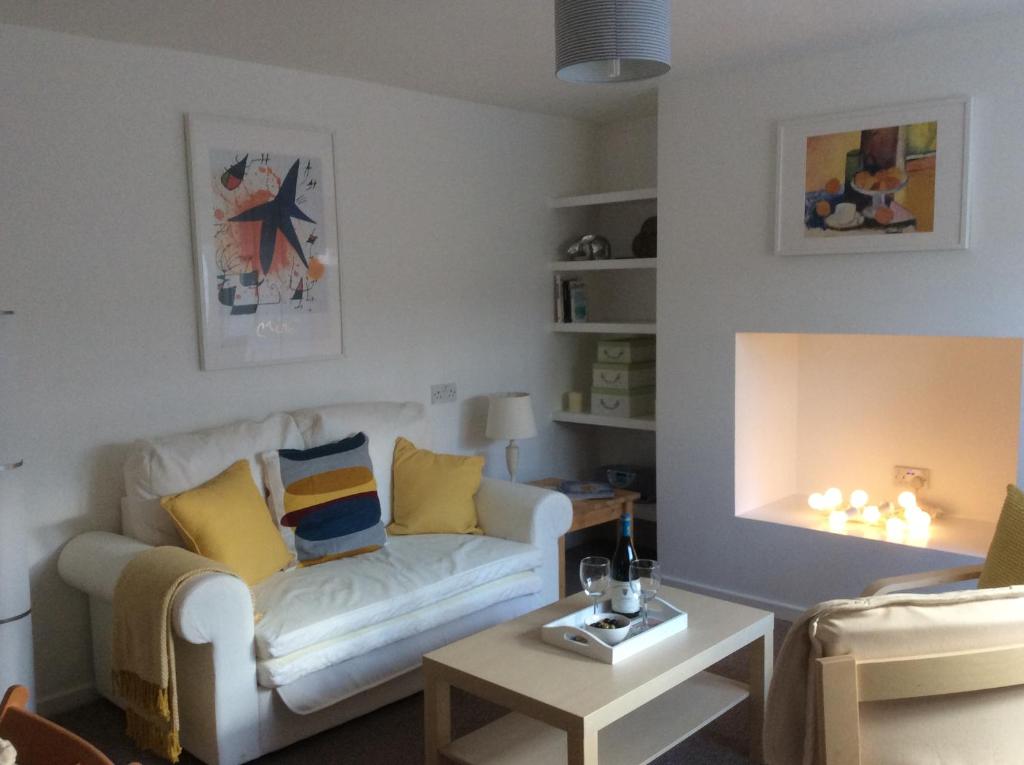 a living room with a couch and a table at Perfect for Caernarfon Castle, Snowdon, & Zip World in Caernarfon