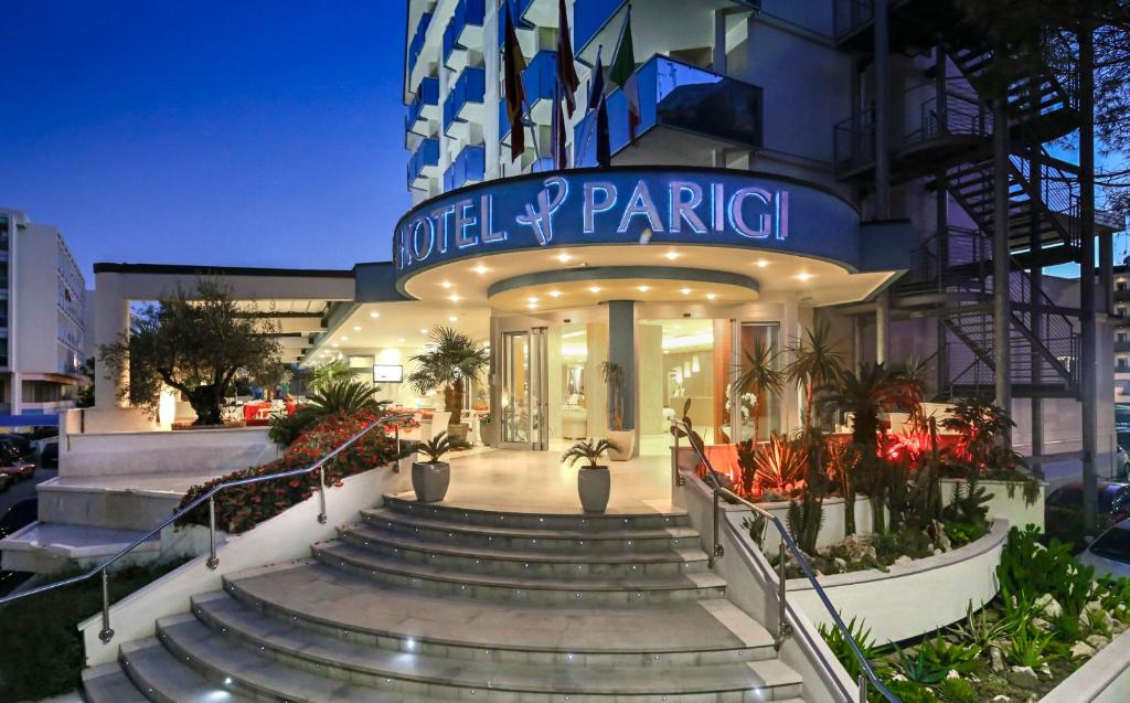 a building with stairs in front of a building at Hotel Parigi in Bibione