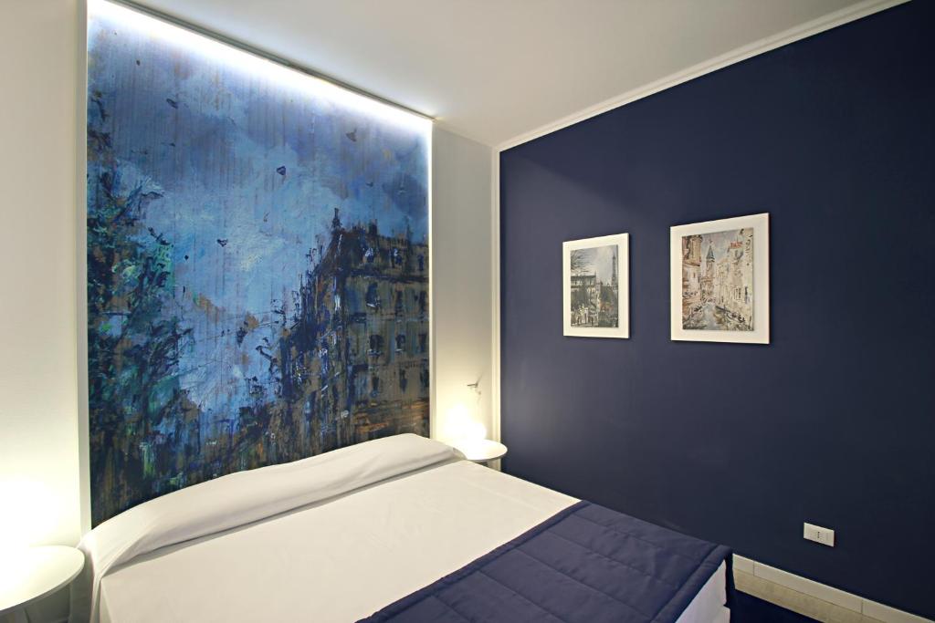 Łóżko lub łóżka w pokoju w obiekcie Ferrara Rooms