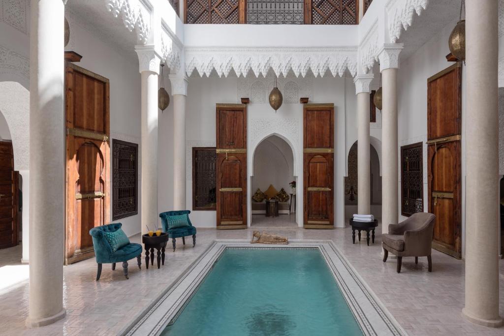 a large room with a swimming pool in a house at Riad Spice by Marrakech Riad in Marrakesh