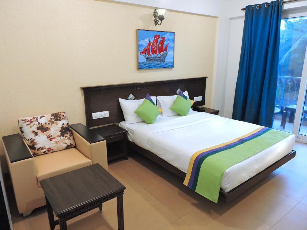 Postel nebo postele na pokoji v ubytování Treebo Premium Dona Eliza, 700 metres from Calangute Beach