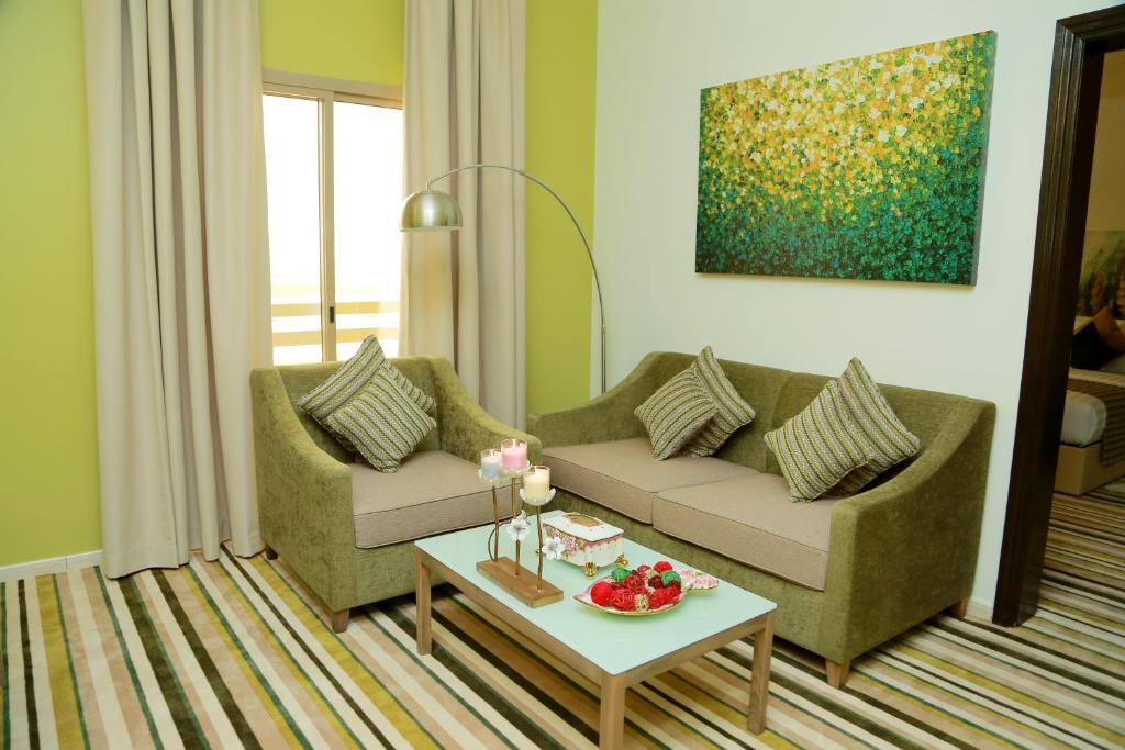 a living room with a couch and a table at Royal View Hotel in Ras al Khaimah