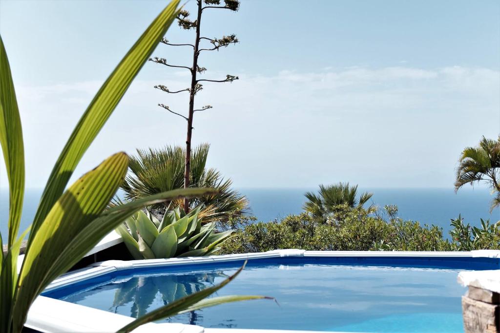 a swimming pool with a view of the ocean at ZenRepublic, your private villa with outdoor jacuzzi & pool with stunning ocean views in Puntillo del Sol
