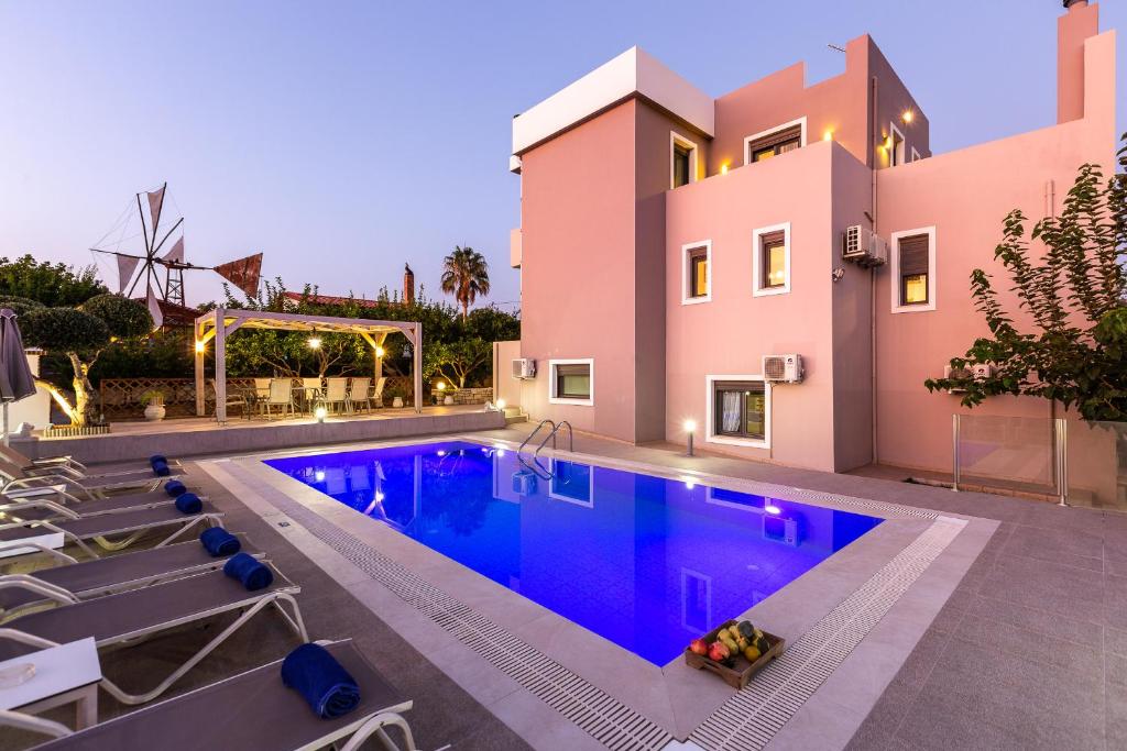 a swimming pool in front of a house at Villa Kalli Crete in Adelianos Kampos