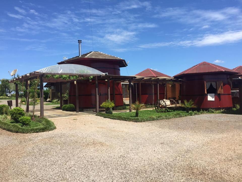 a building with a pavilion in front of it at POUSADA DAS PIPAS in Vacaria